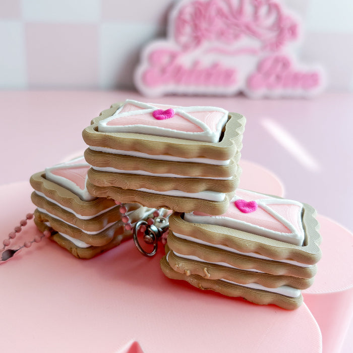 Stack of cookies with pink heart decorations on a pink background