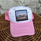 Pink and white foam trucker with prada marfa patch and pearls