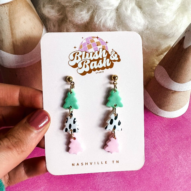 These merry and eye-catching PASTEL CHRISTMAS TREE DANGLE EARRINGS will deck your ears for the holidays! Crafted with the utmost of care, these handmade polymer clay earrings bring Christmas cheer to any ensemble. Look great and feel festive with these cheery additions to your jewelry box!